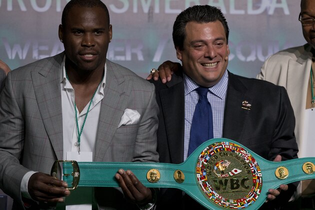 Boxers Adonis Stevenson, left, and Larry Holmes, right, stand with Mauricio Sulaiman, president of the World Boxing Council, during the media presentation of the