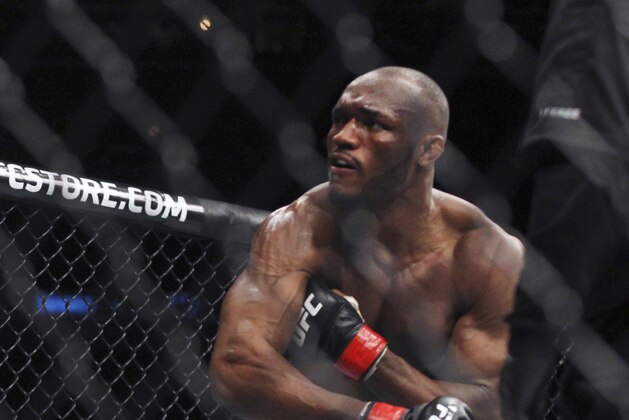 Welterweight Kamaru Usman follows through on punch to Sean Strickland during a mixed martial arts bout at UFC 210, Saturday, April 8, 2017, in Buffalo, N.Y. (AP Photo/Jeffrey T. Barnes)