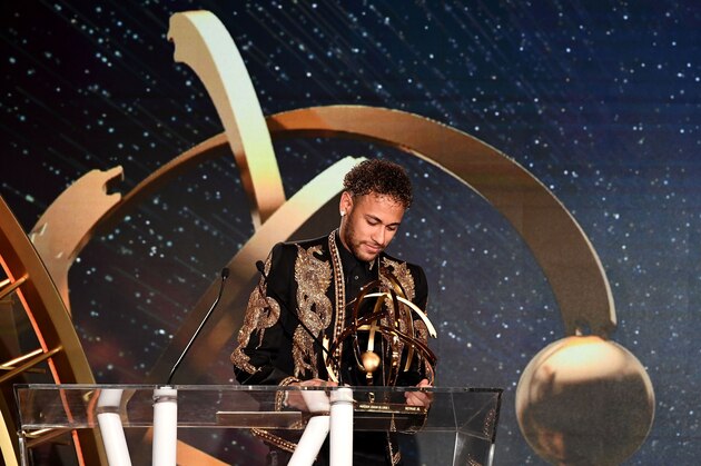 Paris Saint-Germain's Brazilian forward Neymar looks at his trophy as he receives the Best Ligue 1 Player award during a TV show on May 13, 2018 in Paris, as part of the 27th edition of the UNFP (French National Professional Football players Union) trophy ceremony. (Photo by FRANCK FIFE / AFP)        (Photo credit should read FRANCK FIFE/AFP/Getty Images)