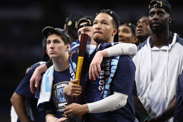 SAN ANTONIO, TX - APRIL 02:  Collin Gillespie #2 and Jalen Brunson #1 of the Villanova Wildcats watch 'One Shining Moment' while celebrating after defeating the Michigan Wolverines during the 2018 NCAA Men's Final Four National Championship game at the Alamodome on April 2, 2018 in San Antonio, Texas. Villanova defeated Michigan 79-62.  (Photo by Ronald Martinez/Getty Images)