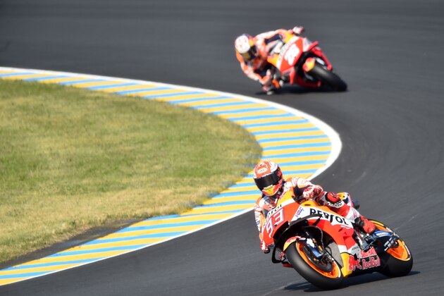 Repsol Honda Team's Spanish rider Marc Marquez drives ahead Repsol Honda Team's Spanish rider Dani Pedrosa during the warm-up ahead of the French motorcycling Grand Prix on May 20, 2018 in Le Mans, northwestern France. (Photo by JEAN-FRANCOIS MONIER / AFP)        (Photo credit should read JEAN-FRANCOIS MONIER/AFP/Getty Images)