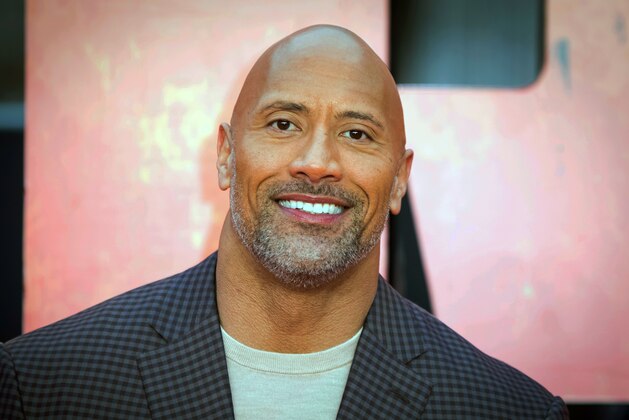 FILE - In this April 11, 2018 file photo, actor Dwayne Johnson poses for photographers at the premiere of the