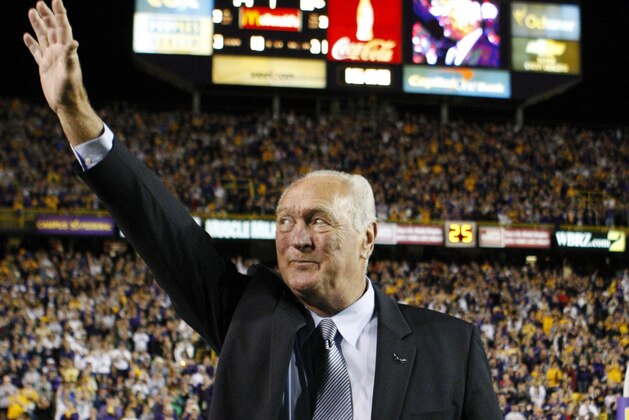 Former LSU running back and Heisman trophy winner Billy Cannon waves to the crowd at the end of the first quarter of the LSU-Tulane NCAA college football game  in Baton Rouge, La., Saturday, Oct. 31, 2009.  This is the 50th anniversary of Cannon's 89-yard  run against Mississippi.  (AP Photo/Bill Haber)