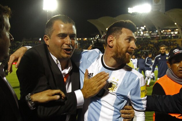 Argentina's Lionel Messi (R) celebrates after defeating Ecuador and qualifying to the 2018 World Cup football tournament, in Quito, on October 10, 2017. / AFP PHOTO / Javier Cazar        (Photo credit should read JAVIER CAZAR/AFP/Getty Images)