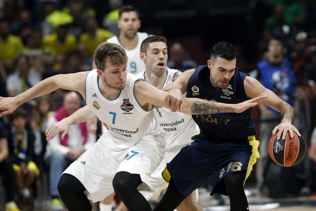 Fenerbahce's Kostas Sloukas dribbles the ball as Real Madrid's Luka Doncic reaches for the ball during their Final Four Euroleague final basketball match between Real Madrid and Fenerbahce in Belgrade, Serbia, Sunday, May 20, 2018. (AP Photo/Darko Vojinovic)