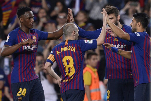 (L-R) Barcelona's Colombian defender Yerry Mina, Barcelona's Spanish midfielder Andres Iniesta, Barcelona's Spanish defender Gerard Pique and Barcelona's Uruguayan forward Luis Suarez celebrate a goal during the Spanish league football match between FC Barcelona and Real Sociedad at the Camp Nou stadium in Barcelona on May 20, 2018. (Photo by Josep LAGO / AFP)        (Photo credit should read JOSEP LAGO/AFP/Getty Images)