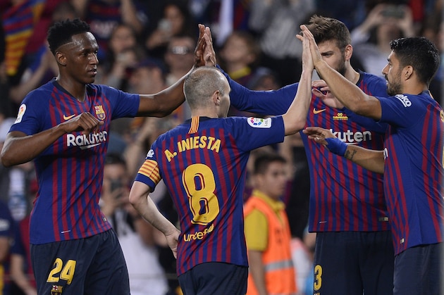 (L-R) Barcelona's Colombian defender Yerry Mina, Barcelona's Spanish midfielder Andres Iniesta, Barcelona's Spanish defender Gerard Pique and Barcelona's Uruguayan forward Luis Suarez celebrate a goal during the Spanish league football match between FC Barcelona and Real Sociedad at the Camp Nou stadium in Barcelona on May 20, 2018. (Photo by Josep LAGO / AFP)        (Photo credit should read JOSEP LAGO/AFP/Getty Images)