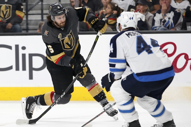 Vegas Golden Knights defenseman Colin Miller, left, shoots past Winnipeg Jets defenseman Josh Morrissey during the second period of Game 4 of the NHL hockey Western Conference finals Friday, May 18, 2018, in Las Vegas. (AP Photo/John Locher)