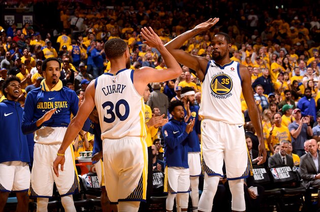 OAKLAND, CA - MAY 20:  Stephen Curry #30 and Kevin Durant #35 of the Golden State Warriors high five during the game against the Houston Rockets in Game Three of the Western Conference Finals of the 2018 NBA Playoffs on May 20, 2018 at ORACLE Arena in Oakland, California. NOTE TO USER: User expressly acknowledges and agrees that, by downloading and or using this photograph, user is consenting to the terms and conditions of Getty Images License Agreement. Mandatory Copyright Notice: Copyright 2018 NBAE (Photo by Noah Graham/NBAE via Getty Images)