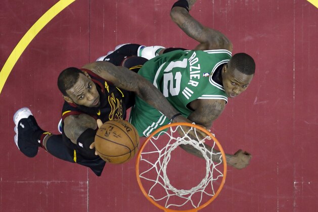 Cleveland Cavaliers' LeBron James, left, drives to the basket against Boston Celtics' Terry Rozier in the second half of Game 3 of the NBA basketball Eastern Conference finals Saturday, May 19, 2018, in Cleveland. The Cavaliers won 116-86. (AP Photo/Tony Dejak)
