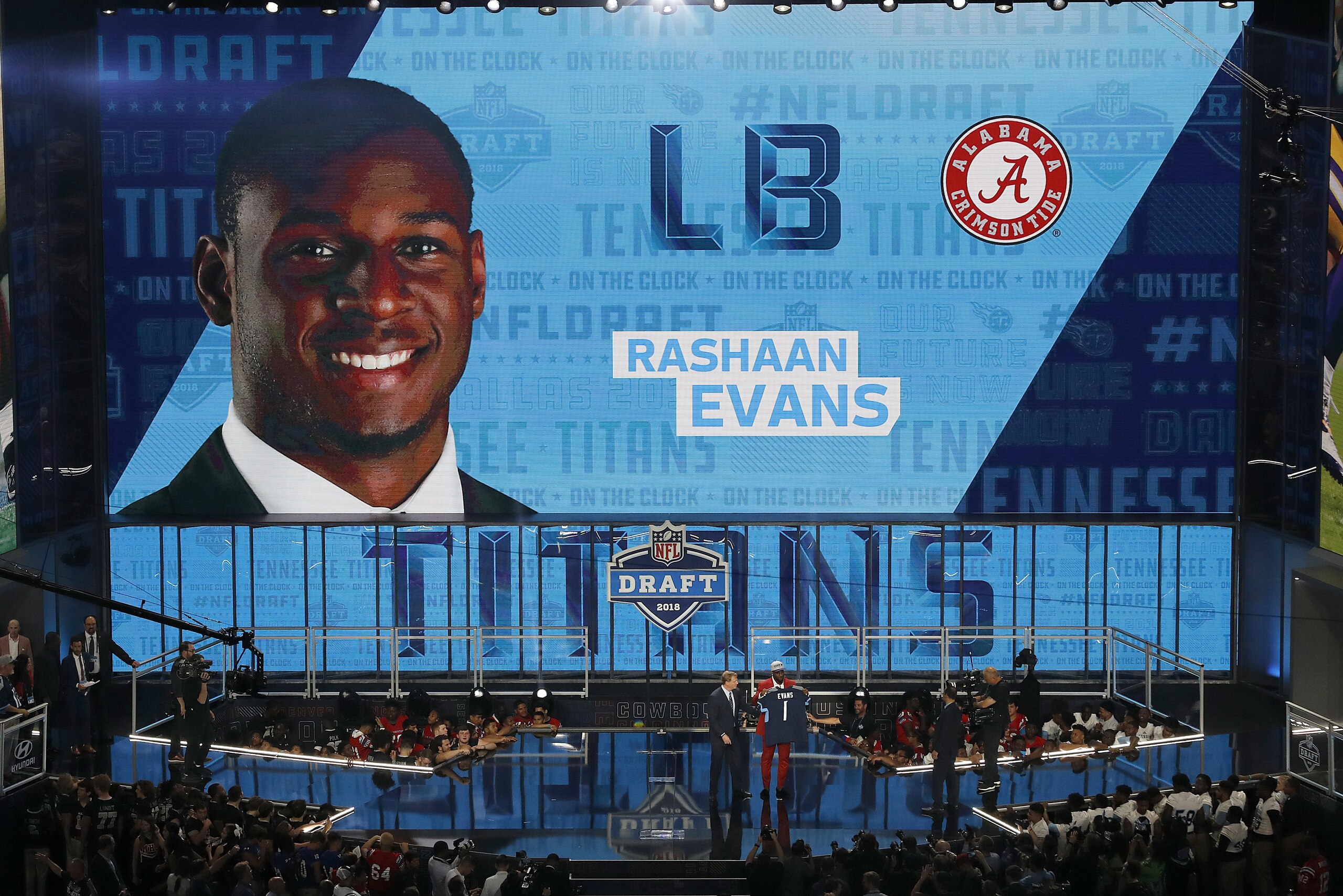 Commissioner Roger Goodell presents Alabama's Rashaan Evans with his Tennessee Titans team jersey during the first round of the NFL football draft, Thursday, April 26, 2018, in Arlington, Texas. (AP Photo/David J. Phillip)