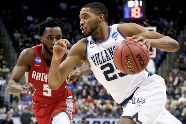 Villanova's Mikal Bridges (25) drives on Radford's Donald Hicks (5) during the second half of an NCAA men's college basketball tournament first-round game Thursday, March 15, 2018, in Pittsburgh. Villanova won 87-61. (AP Photo/Keith Srakocic)