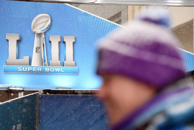 TOPSHOT - A volunteer stands in the snow during the Super Bowl LIVE, a 10-day fan festival leading up to Super Bowl LII, taking place on Minneapolis Nicollet Mall in Downtown Minneapolis, Minnesota February 3, 2018.  / AFP PHOTO / ANGELA WEISS        (Photo credit should read ANGELA WEISS/AFP/Getty Images)