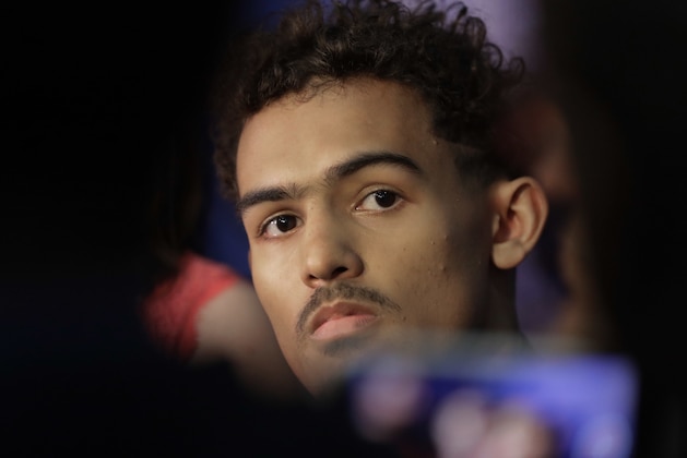 Trae Young, center, from Oklahoma, listens to a question during the interview segment at the NBA draft basketball combine Friday, May 18, 2018, in Chicago. (AP Photo/Charles Rex Arbogast)