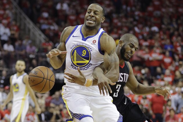 Golden State Warriors forward Andre Iguodala (9) is fouled by Houston Rockets guard Chris Paul (3) during the second half of Game 1 of the NBA basketball Western Conference Finals, Monday, May 14, 2018, in Houston. (AP Photo/David J. Phillip)
