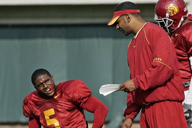 Southern California tail back Reggie Bush, left, listens to running backs coach Todd McNair, center, as LenDale White looks on during a work-out in Los Angeles Thursday, Dec. 29, 2005. The Trojans face the University of Texas  in the national championship game at the Rose Bowl on Wednesday, Jan. 4, 2006. (AP Photo/Kevork Djansezian)