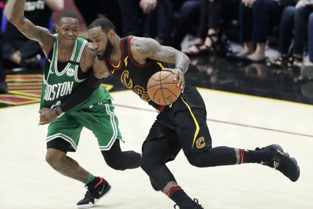 Cleveland Cavaliers' LeBron James drives on Boston Celtics' Terry Rozier in the first half of Game 4 of the NBA basketball Eastern Conference finals, Monday, May 21, 2018, in Cleveland. (AP Photo/Tony Dejak)