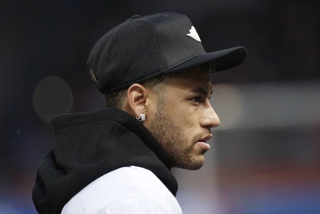 Injured PSG player Neymar walks to the bench prior to the League One soccer match between Paris Saint-Germain and Stade Rennais at the Parc des Princes stadium in Paris, Saturday May 12, 2018. (AP Photo/Christophe Ena)