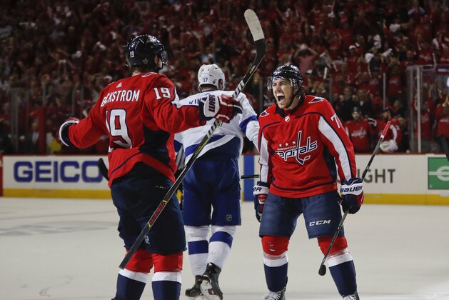 Washington Capitals right wing T.J. Oshie (77) celebrates his goal against the Tampa Bay Lightning with teammate Washington Capitals center Nicklas Backstrom (19), from Sweden, during the second period of Game 6 of the NHL Eastern Conference finals hockey playoff series, Monday, May 21, 2018, in Washington. Skating away is Tampa Bay Lightning left wing Alex Killorn (17). (AP Photo/Pablo Martinez Monsivais)