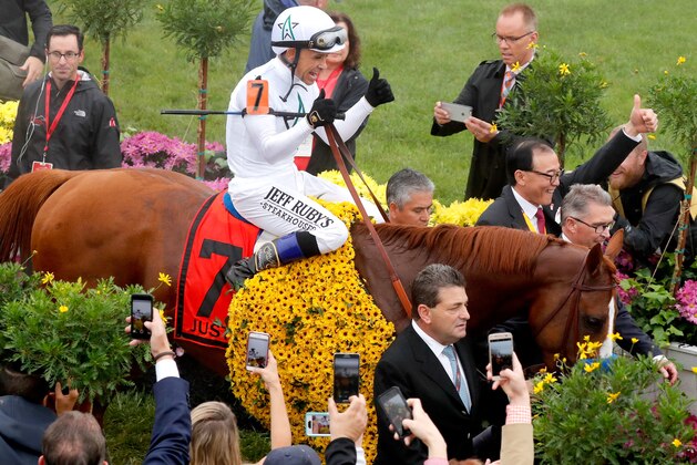 BALTIMORE, MD - MAY 19:  Jockey Mike Smith and racing horse Justify enter the winners circle at the 143rd Preakness Stakes on May 19, 2018 in Baltimore, Maryland.  (Photo by Paul Morigi/Getty Images for The Stronach Group)