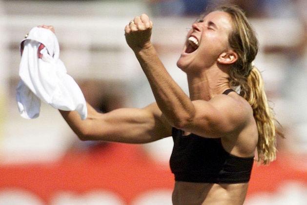 Brandi Chastain of the US celebrates after kicking the winning penalty shot to win the 1999 Women's World Cup final against China 10 July 1999 at the Rose Bowl in Pasadena. The US won 5-4 on penalty kicks.  (ELECTRONIC IMAGE)   AFP PHOTO/Roberto SCHMIDT / AFP / ROBERTO SCHMIDT        (Photo credit should read ROBERTO SCHMIDT/AFP/Getty Images)