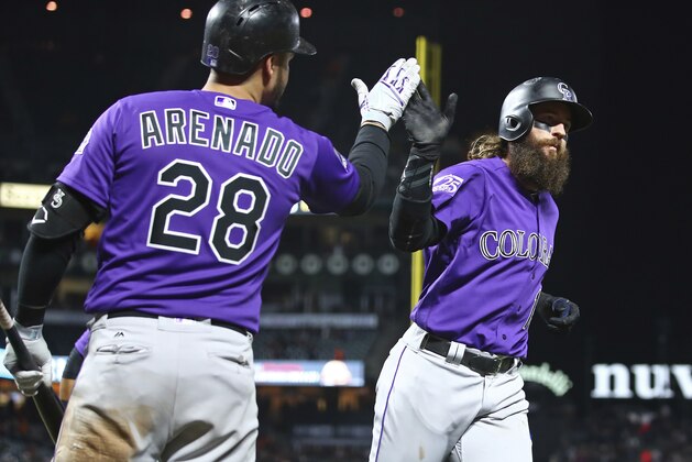 Colorado Rockies' Charlie Blackmon, right, celebrates with Nolan Arenado (28) after hitting a two run home run off San Francisco Giants' Jose Valdez in the ninth inning of a baseball game Friday, May 18, 2018, in San Francisco. (AP Photo/Ben Margot)