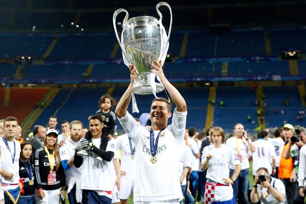 Real Madrid's Cristiano Ronaldo celebrates with the trophy after the Champions League final soccer match between Real Madrid and Atletico Madrid at the San Siro stadium in Milan, Italy, Saturday, May 28, 2016. Real Madrid won 5-3 on penalties after the match ended 1-1 after extra time.   (AP Photo/Antonio Calanni)