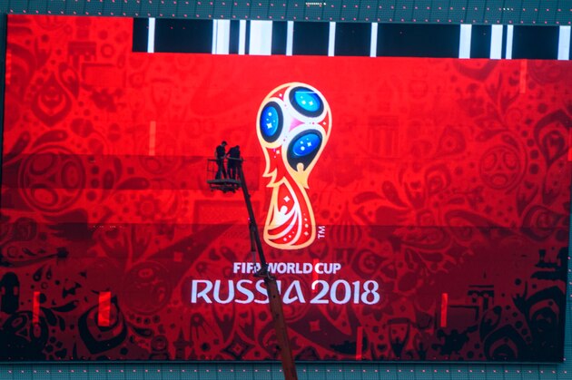 TOPSHOT - Workers fix a giant screen featuring the Russian FIFA World Cup logo, mounted outside Rostov Arena in the southern Russian city of Rostov-on-Don on May 12, 2018. - The stadium will host five football matches of the 2018 FIFA World Cup. (Photo by Mladen ANTONOV / AFP)        (Photo credit should read MLADEN ANTONOV/AFP/Getty Images)