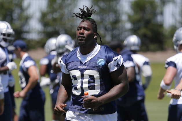 Dallas Cowboys defensive end Demarcus Lawrence (90) jogs off the field after an NFL football organized team activities practice at the team's training facility, Wednesday, May 24, 2017, in Frisco, Texas. (AP Photo/Tony Gutierrez)