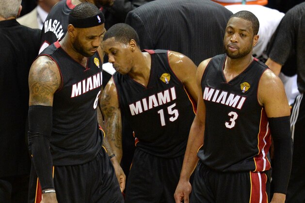 LeBron James #6, Mario Chalmers #15 and Dwyane Wade #3 of the Miami Heat return to the court against the San Antonio Spurs during Game 5 of the NBA Finals on June 15, 2014 in San Antonio,Texas.  The Spurs defeat the Miami Heat 107-84 in Game 5 of the NBA Finals to win the NBA Finals Championship,  June 15, 2014 in San Antonio,Texas.  The Spurs won the best of seven series 4-1.  AFP PHOTO / Robyn Beck        (Photo credit should read ROBYN BECK/AFP/Getty Images)