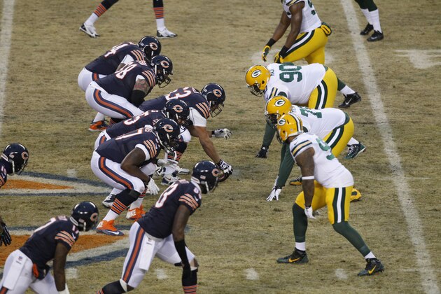 The Chicago Bears and Green Bay Packers square of at the line of scrimmage during the first half of an NFL football game, Sunday, Dec. 29, 2013, in Chicago. (AP Photo/Kiichiro Sato)
