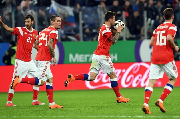 Russia's forward Fyodor Smolov (2nd R) celebrates after scoring a goal during an international friendly football match between Russia and France at the Saint Petersburg Stadium in Saint Petersburg on March 27, 2018. / AFP PHOTO / Kirill KUDRYAVTSEV        (Photo credit should read KIRILL KUDRYAVTSEV/AFP/Getty Images)