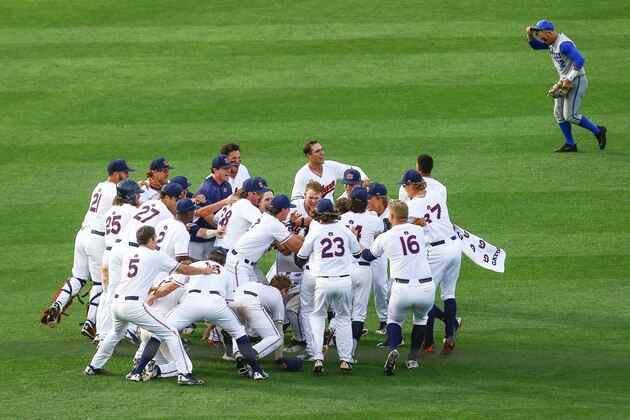 Kentucky outfielder Ben Aklinski (52) jogs off the field as Auburn players celebrate their win with Auburn infielder Edouard Julien (10) after he drove in the winning run during the 11th inning of a Southeastern Conference tournament NCAA college baseball game Tuesday, May 22, 2018, in Hoover, Ala. Auburn won 4-3. (AP Photo/Butch Dill)