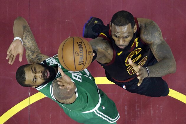 Cleveland Cavaliers' LeBron James, right, drives to the basket against Boston Celtics' Marcus Morris in the second half of Game 4 of the NBA basketball Eastern Conference finals, Monday, May 21, 2018, in Cleveland. The Cavaliers won 111-102. (AP Photo/Tony Dejak)