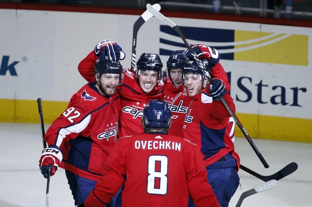 Washington Capitals left wing Alex Ovechkin (8), from Russia, comes to join center Evgeny Kuznetsov, left, from Russia, right wing T.J. Oshie, center Nicklas Backstrom (19), from Sweden, and defenseman John Carlson as they celebrate a goal by Oshie during the second period of Game 6 of the NHL Eastern Conference finals hockey playoff series against the Tampa Bay Lightning, Monday, May 21, 2018, in Washington. (AP Photo/Alex Brandon)