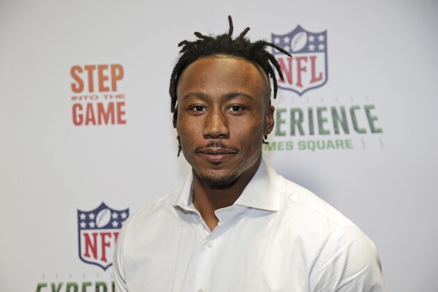 New York Giants Brandon Marshall poses for a picture at the opening of