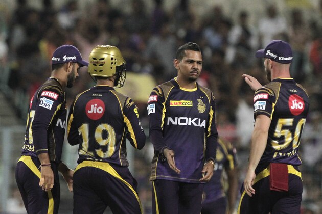Kolkata Knight Riders' Sunil Narine, center being congratulated by teammates after taking wicket of Sunrisers Hyderabad's Wriddhiman Saha during VIVO IPL cricket T20 match in Kolkata, India, Saturday, April 14, 2018. (AP Photo/Bikas Das)