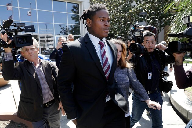 FILE - In this April 12, 2018, file photo, San Francisco 49ers linebacker Reuben Foster, center, exits the Santa Clara County Superior Court after his arraignment in San Jose, Calif. Prosecutors say the ex-girlfriend of Foster has submitted a video to support her statement that she lied when she told authorities Foster had hit her. But Santa Clara County prosecutor Jim Dermertzis said Monday, April 30, 2018, the district attorney's office will continue to prosecute the domestic violence case against Foster even if his ex-girlfriend, Elissa Ennis, does not cooperate with the investigation. (AP Photo/Marcio Jose Sanchez, File)