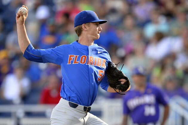 FILE - In this June 26, 2017, file photo, Florida pitcher Brady Singer (51) throws in the first inning of Game 1 of the NCAA College World Series baseball finals against LSU in Omaha, Neb. What the Florida baseball team is doing this season is downright ridiculous, even for a defending national champion that looks primed to repeat The top-ranked Gators have won every weekend series they've played in 2018, stretching their eye-popping streak to 17 in a row. (AP Photo/Matt Ryerson, File)
