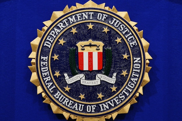 The Federal Bureau of Investigation (FBI) seal is seen on the lectern following a press conference announcing the FBI's 499th and 500th additions to the 'Ten Most Wanted Fugitives' list on June 17, 2013 at the Newseum in Washington, DC. AFP PHOTO/Mandel NGAN        (Photo credit should read MANDEL NGAN/AFP/Getty Images)