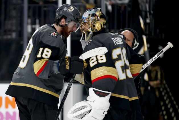 Vegas Golden Knights left wing James Neal, left, celebrates the team's 3-2 win with Marc-Andre Fleury after Game 4 of the NHL hockey Western Conference finals agains the Winnipeg Jets on Friday, May 18, 2018, in Las Vegas. (AP Photo/John Locher)