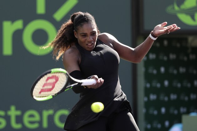 In this photo taken on Wednesday, March 21, 2018, Serena Williams returns to Naomi Osaka of Japan, during the Miami Open tennis tournament, in Key Biscayne, Fla. Serena Williams' coach says she will play the French Open beginning in two weeks. The tournament will mark the 23-time Grand Slam champion's first major since returning to the tour from maternity leave. Coach Patrick Mouratoglou tells the WTA tour's website,