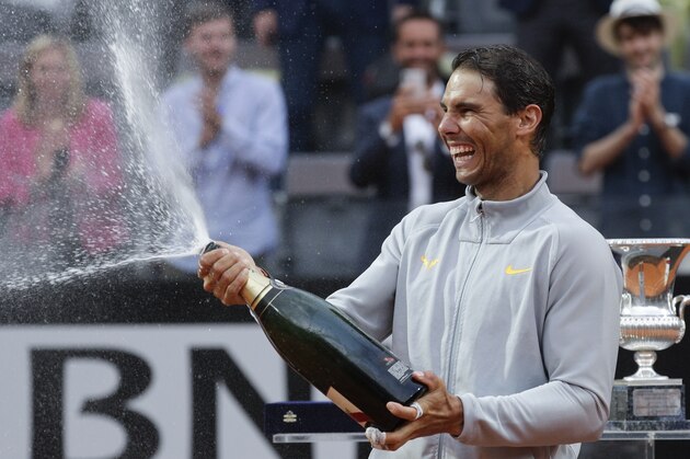 FILE - In this May 20, 2018, file photo, Spain's Rafael Nadal sprays sparkling wine as he celebrates defeating Germany's Alexander Zverev in the final match of the Italian Open tennis tournament in Rome. Nadal is 79-2 for his career in the French Open, a .975 winning percentage. (AP Photo/Gregorio Borgia, File)