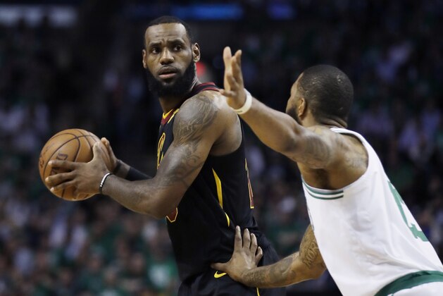 Cleveland Cavaliers forward LeBron James keeps the ball from Boston Celtics forward Marcus Morris during the first quarter of Game 5 of the NBA basketball Eastern Conference finals Wednesday, May 23, 2018, in Boston. (AP Photo/Charles Krupa)