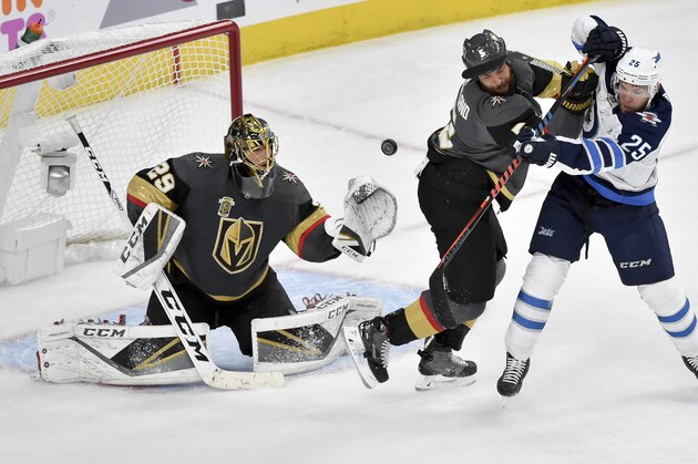 Vegas Golden Knights goaltender Marc-Andre Fleury, left, and defenseman Deryk Engelland, middle, defend against Winnipeg Jets center Paul Stastny during the second period of Game 3 of the NHL hockey playoffs Western Conference finals Wednesday, May 16, 2018, in Las Vegas. (AP Photo/David Becker)