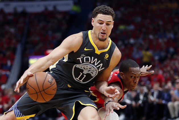 Golden State Warriors guard Klay Thompson (11) drives to the basket against New Orleans Pelicans guard Rajon Rondo during the first half of Game 3 of a second-round NBA basketball playoff series in New Orleans, Friday, May 4, 2018. (AP Photo/Gerald Herbert)