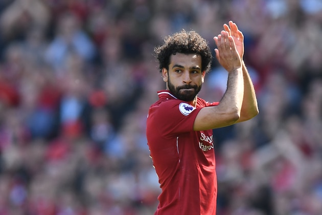 Liverpool's Egyptian midfielder Mohamed Salah applauds fans as he is substituted during the English Premier League football match between Liverpool and Brighton and Hove Albion at Anfield in Liverpool, north west England on May 13, 2018. (Photo by Paul ELLIS / AFP) / RESTRICTED TO EDITORIAL USE. No use with unauthorized audio, video, data, fixture lists, club/league logos or 'live' services. Online in-match use limited to 75 images, no video emulation. No use in betting, games or single club/league/player publications. /         (Photo credit should read PAUL ELLIS/AFP/Getty Images)