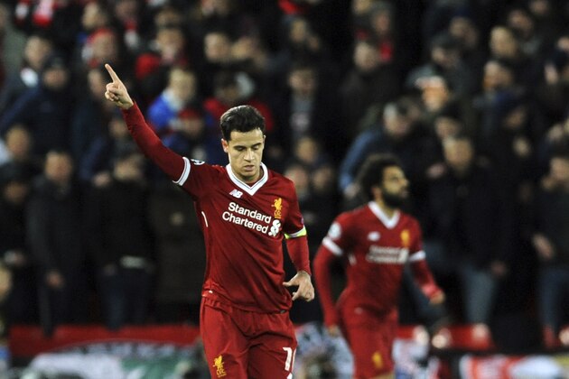 Liverpool's Philippe Coutinho, left, celebrates after scoring his side's second goal during the Champions League Group E soccer match between Liverpool and Spartak Moscow at Anfield, Liverpool, England, Wednesday, Dec. 6, 2017. (AP Photo/Rui Vieira)