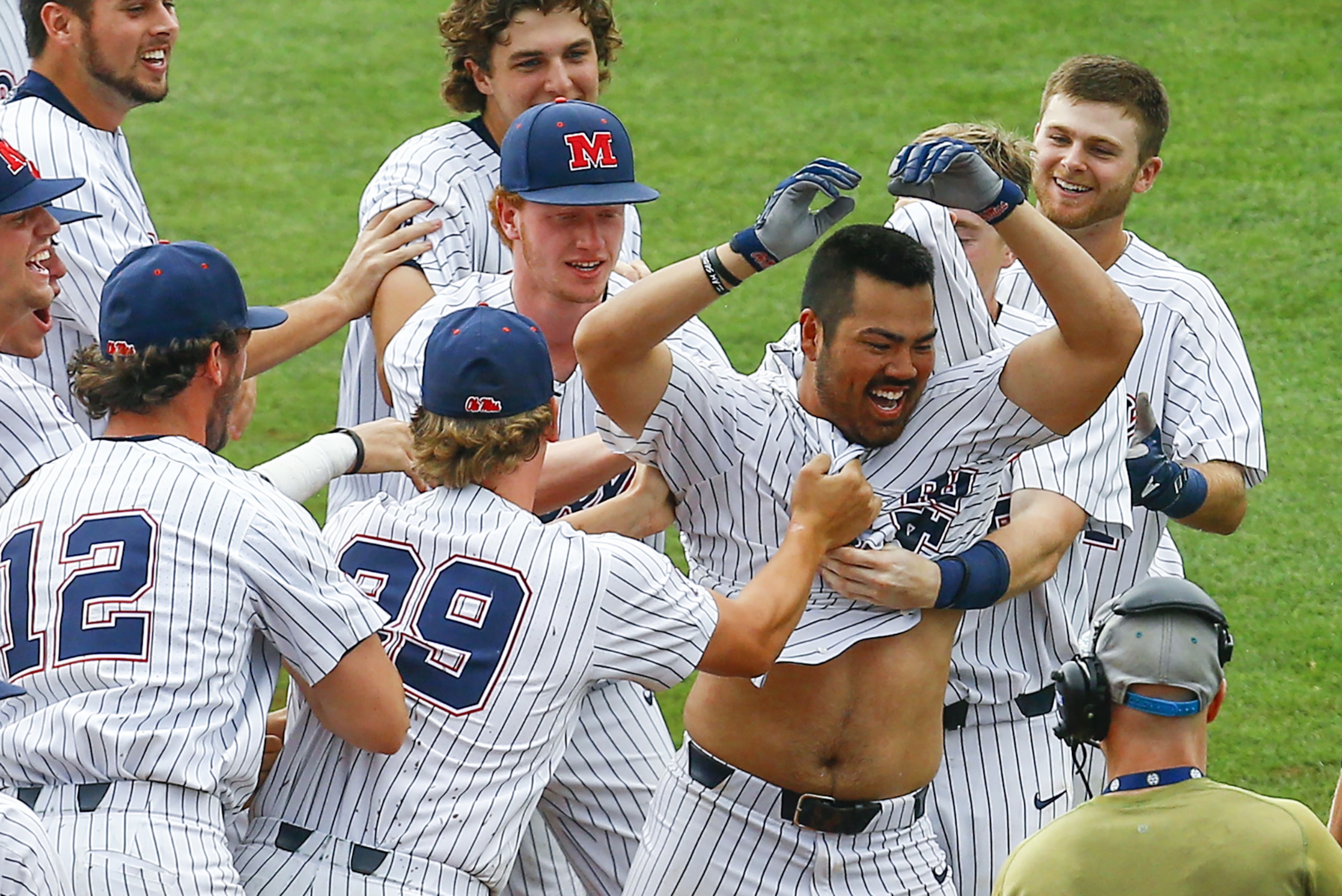 Mississippi's Tim Rowe (42) celebrates with teammates after knocking in the game winning run on a single during the 10th inning of a Southeastern Conference Tournament NCAA college baseball game against Georgia, Thursday, May 24, 2018, in Hoover, Ala. (AP Photo/Butch Dill) Mississippi's Tim Rowe (42) celebrates with teammates after knocking in the game winning run on a single during the 10th inning of a Southeastern Conference Tournament NCAA college baseball game against Georgia, Thursday, May 24, 2018, in Hoover, Ala. (AP Photo/Butch Dill)