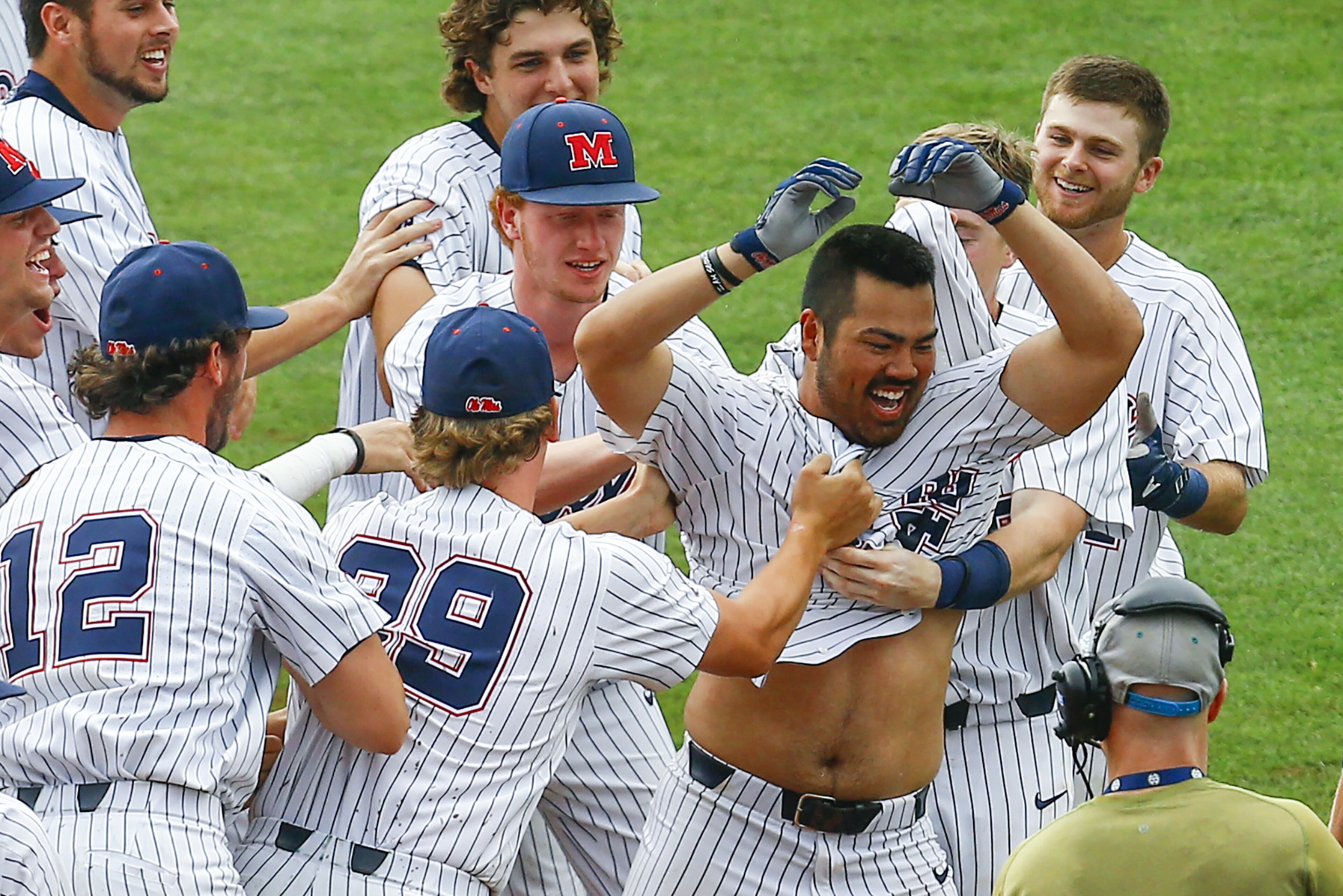 Mississippi's Tim Rowe (42) celebrates with teammates after knocking in the game winning run on a single during the 10th inning of a Southeastern Conference Tournament NCAA college baseball game against Georgia, Thursday, May 24, 2018, in Hoover, Ala. (AP Photo/Butch Dill)